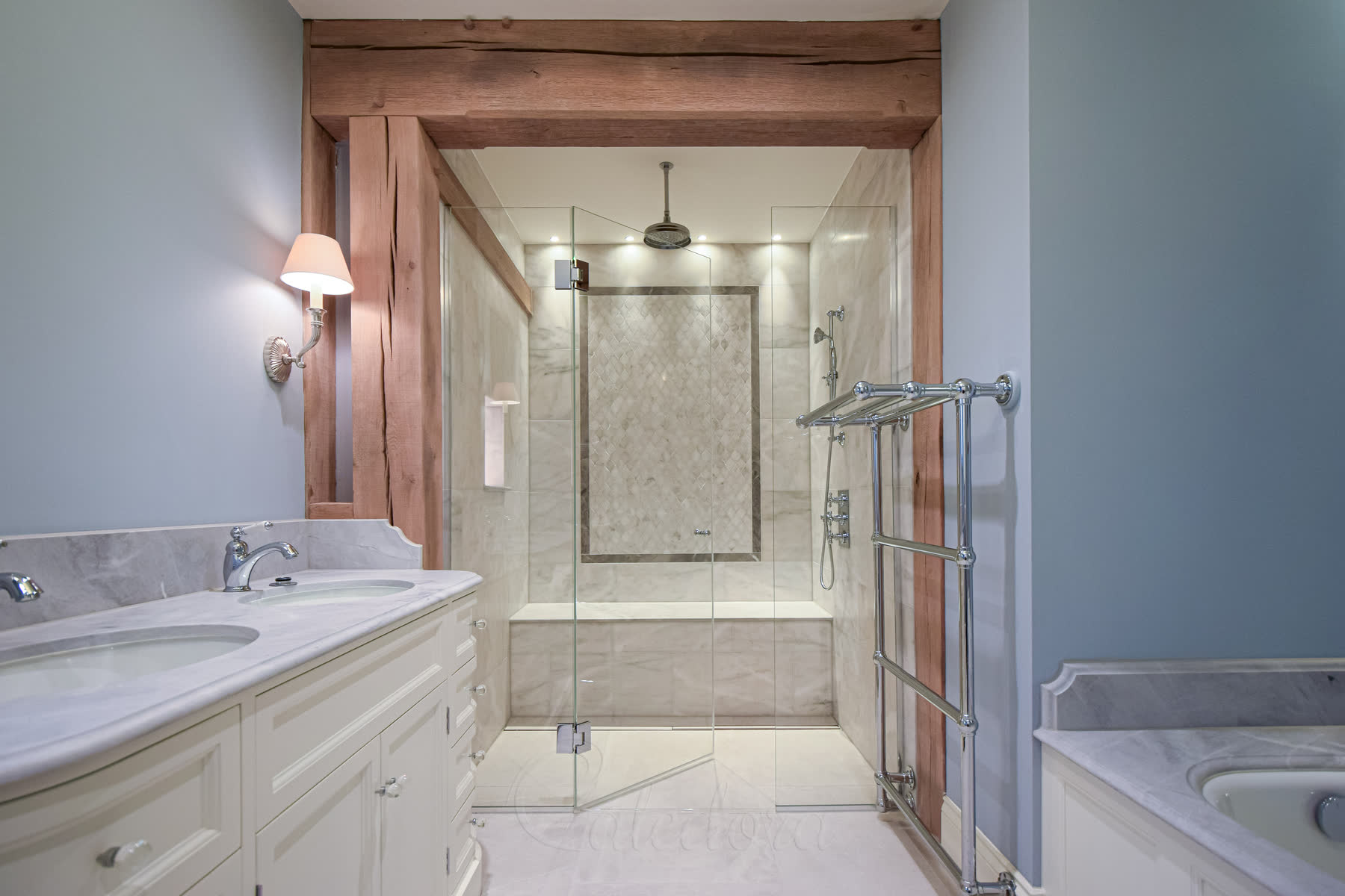 Bathroom overview with shower door partially opened showing tiled bench inside the shower area