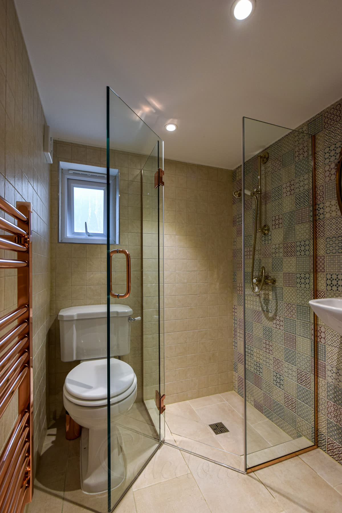 Diamond shower enclosure in a small London bathroom showing the angled door clearing side fixtures
