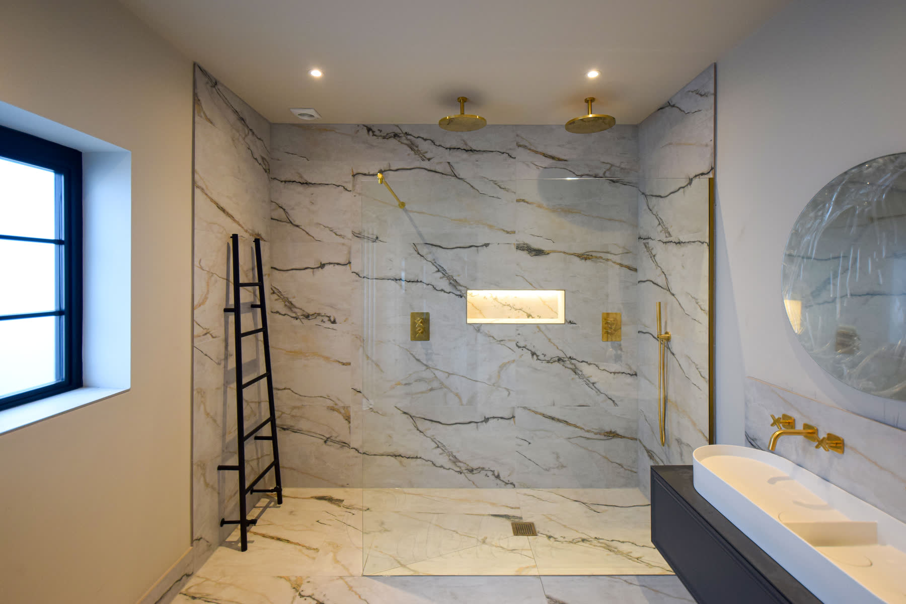Landscape overall view of the brushed brass shower screen including towel rack and entry point