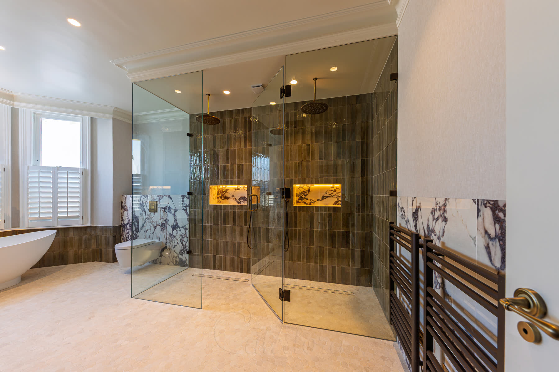 Large shower cubicle corner view showing frameless glass panels with walk-in floor design