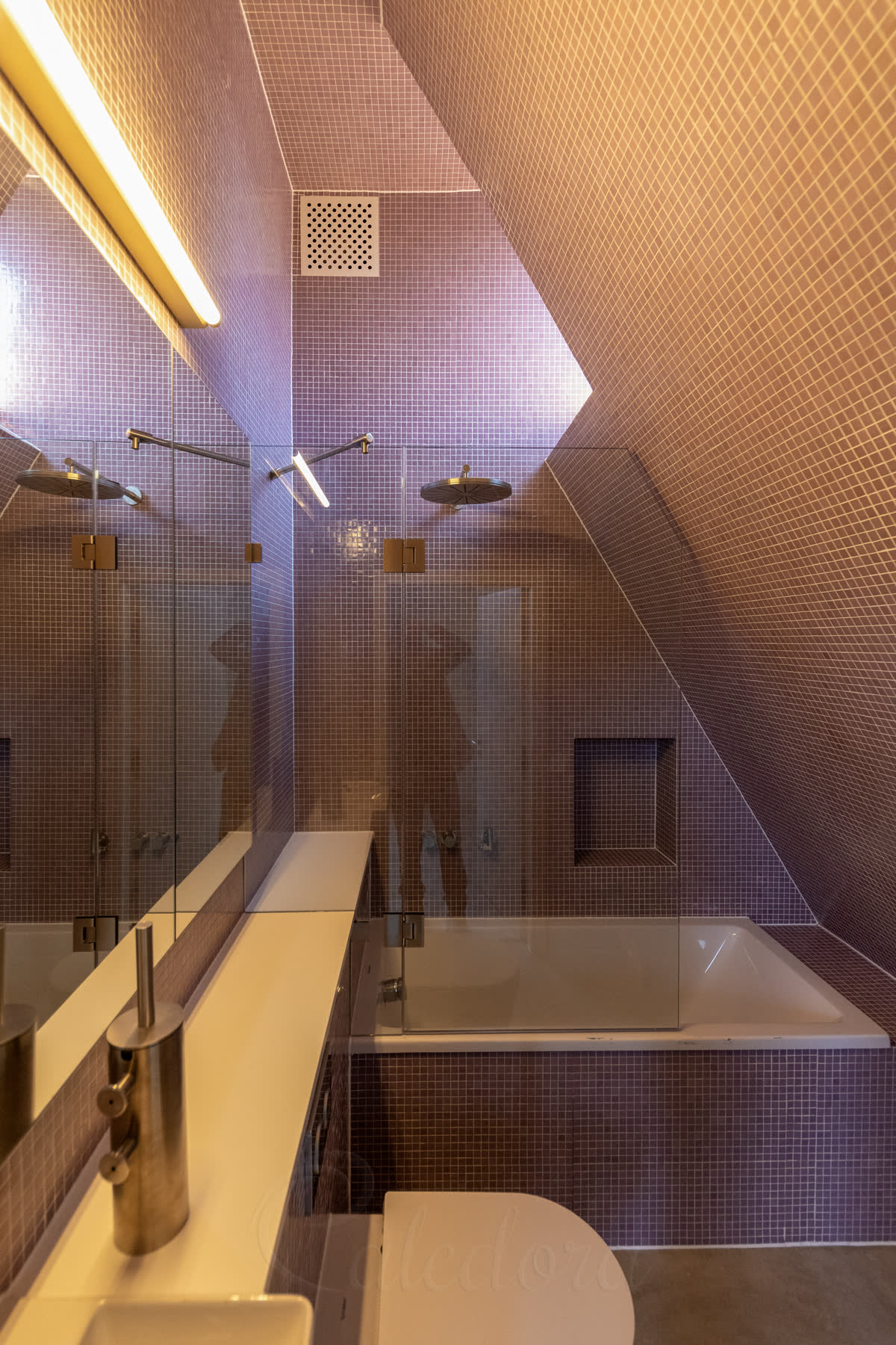Mirrored loft bath screen in the second bathroom of the same house with purple mosaic tiles and identical CNC notch geometry