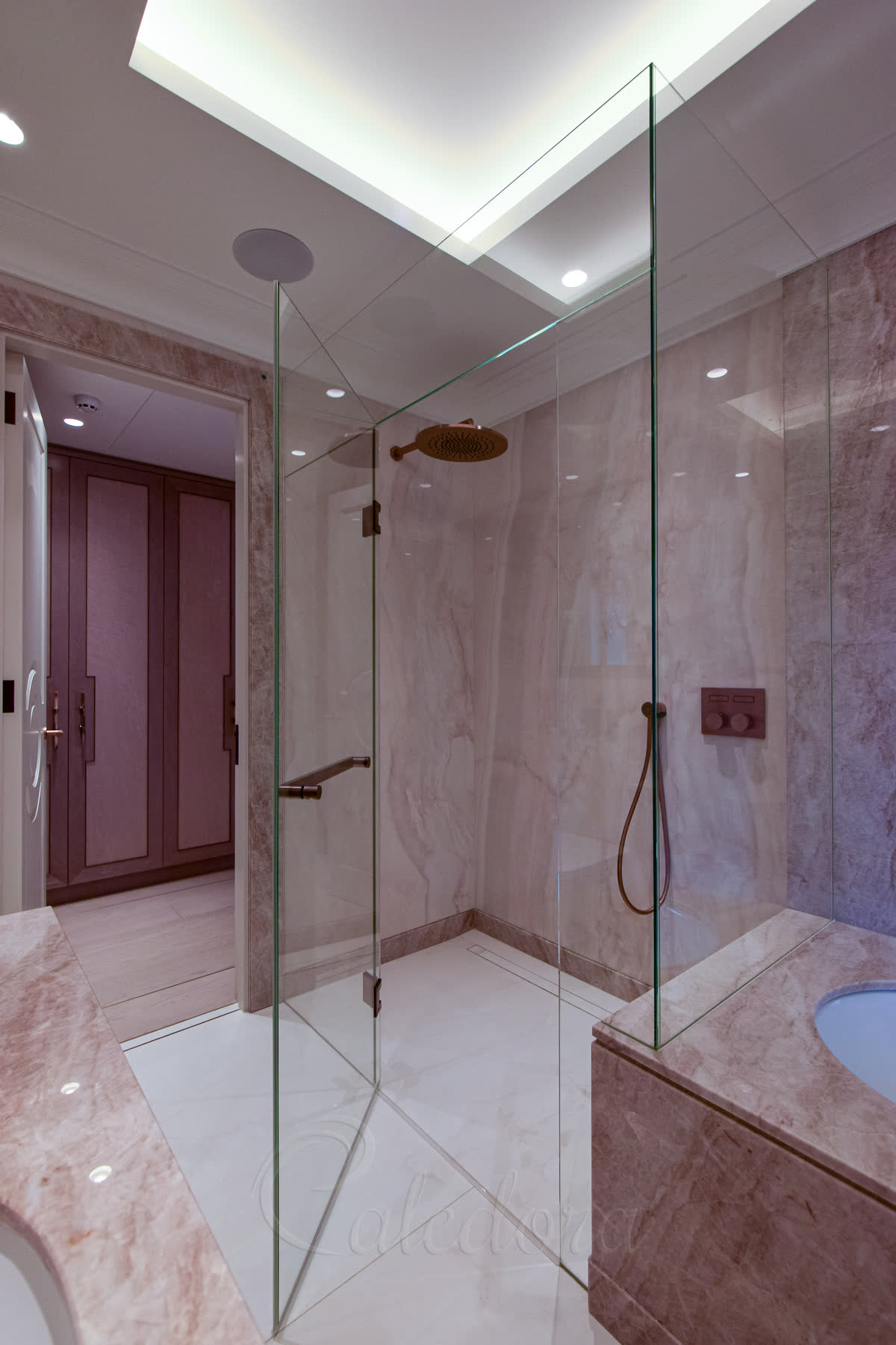 Luxury shower enclosure with door partially open showing copper hinges and handle