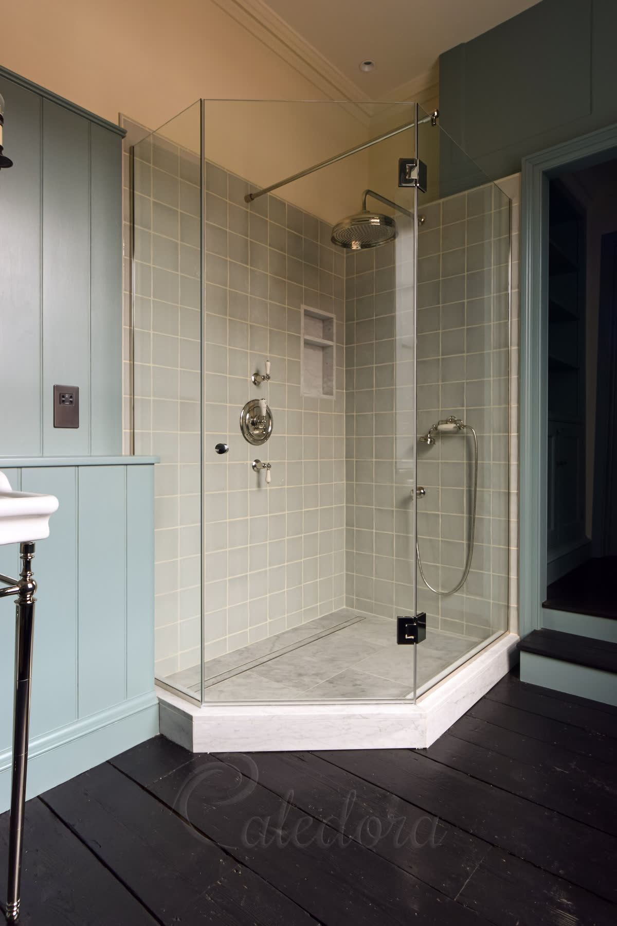 Frameless pentagon shower enclosure with nickel fittings and ultra clear glass