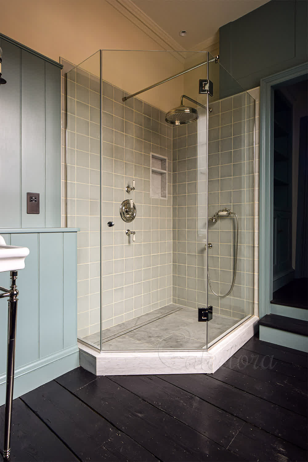 Frameless pentagon shower enclosure with nickel fittings and ultra clear glass