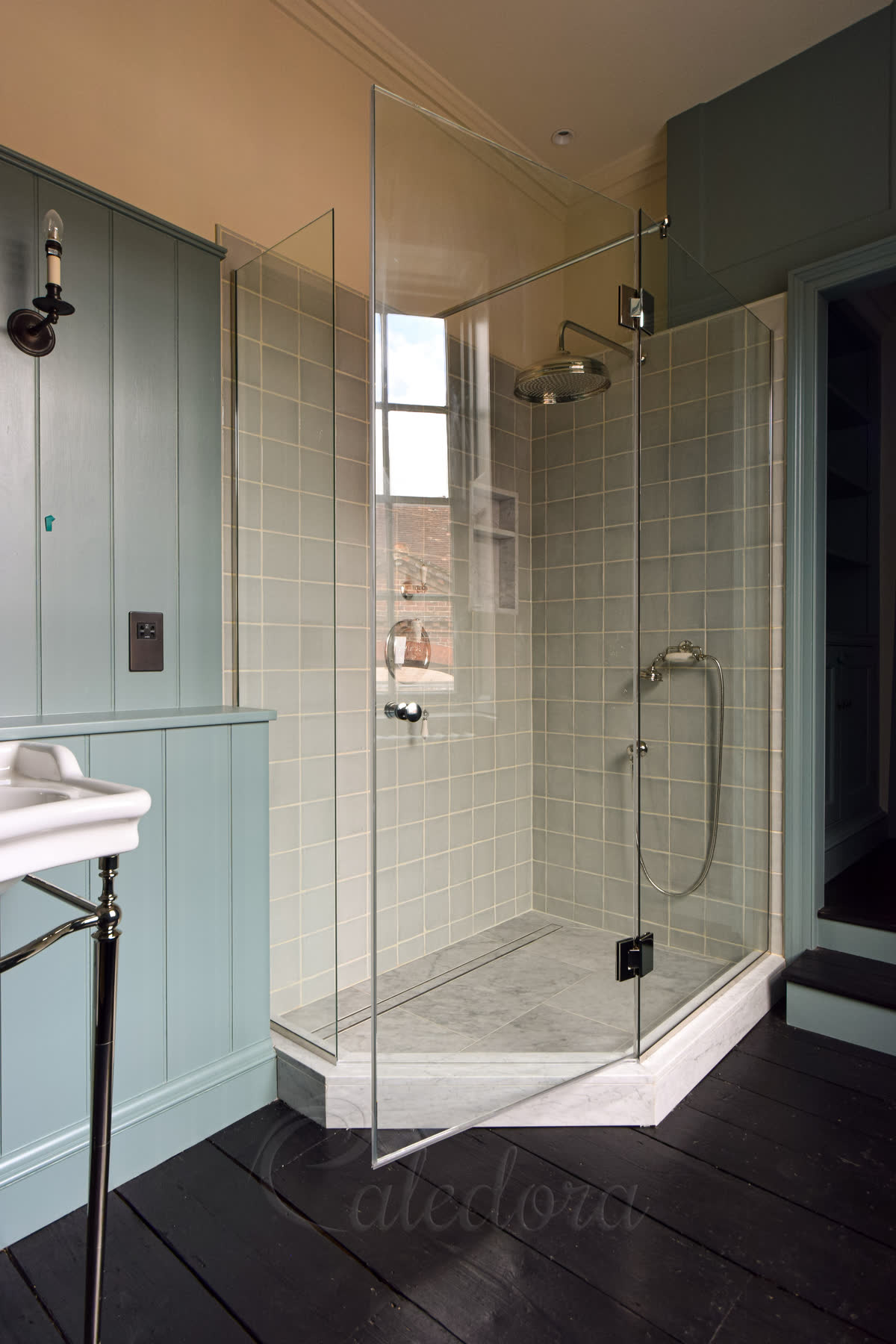 Custom pentagon shower enclosure with nickel fittings and traditional doorknob