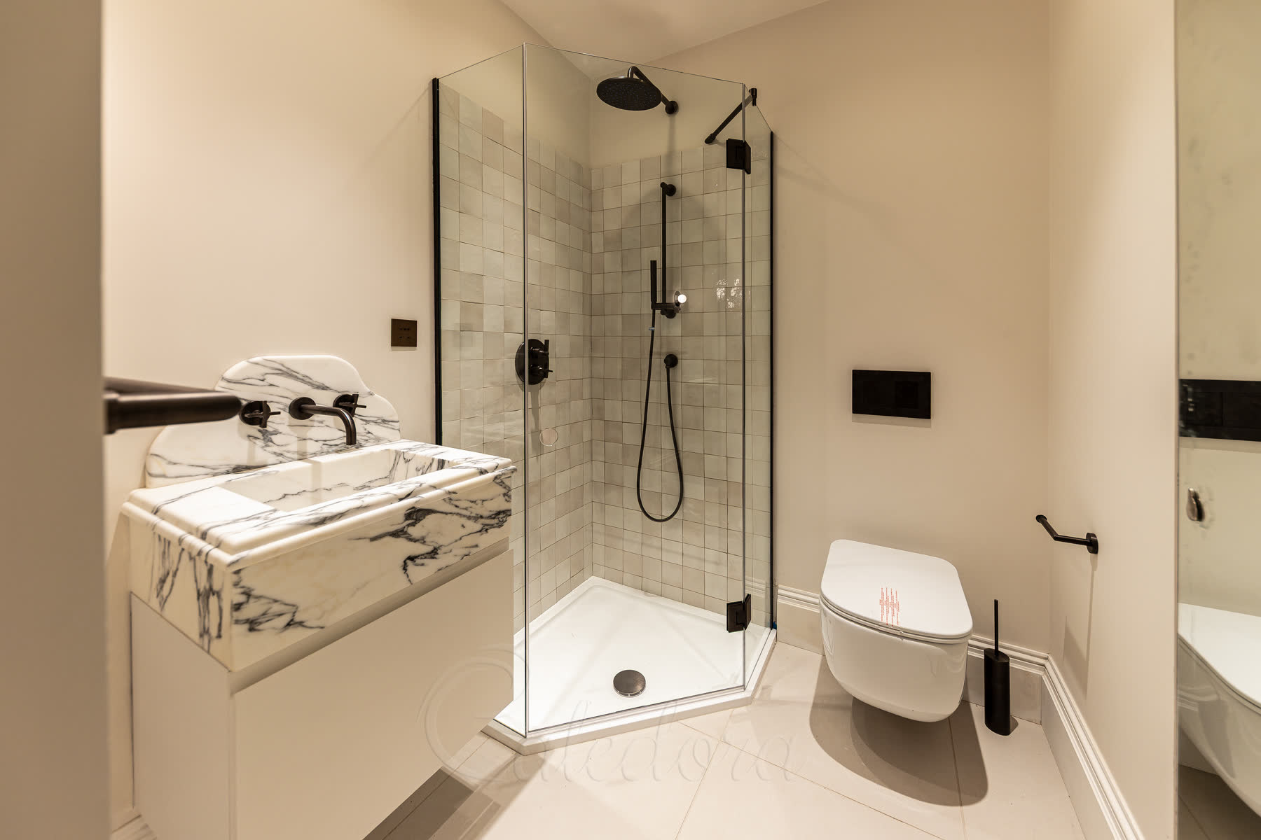 Pentagon shower enclosure bathroom overview showing compact design with vanity and toilet placement