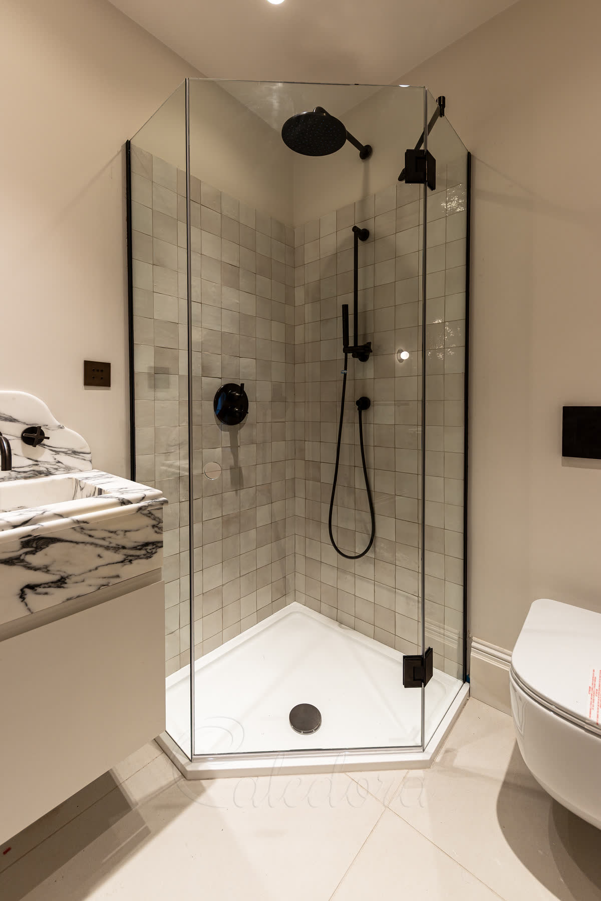 Pentagon shower enclosure with gunmetal finish in corner bathroom installation with 135-degree hinges