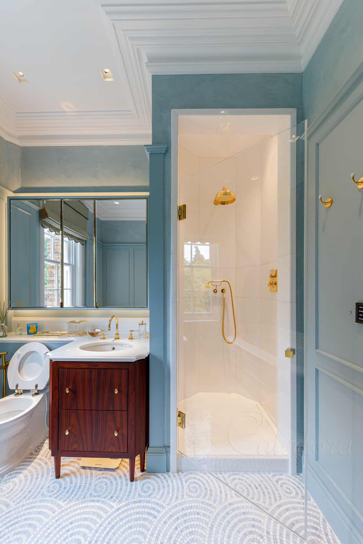 Polished brass shower door partially open at 45 degrees displaying minimalistic door seals and smooth operation