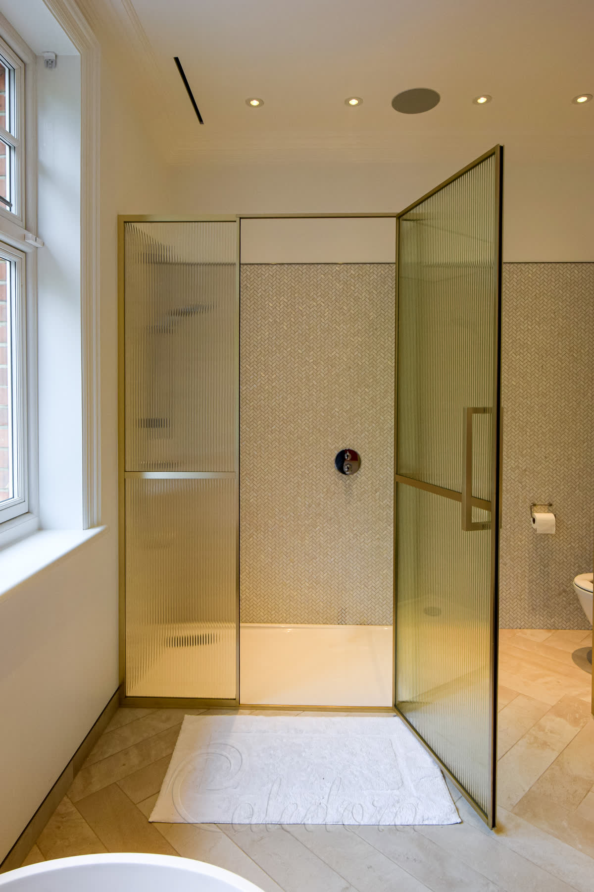 Light gold framed shower enclosure with door open showing interior space