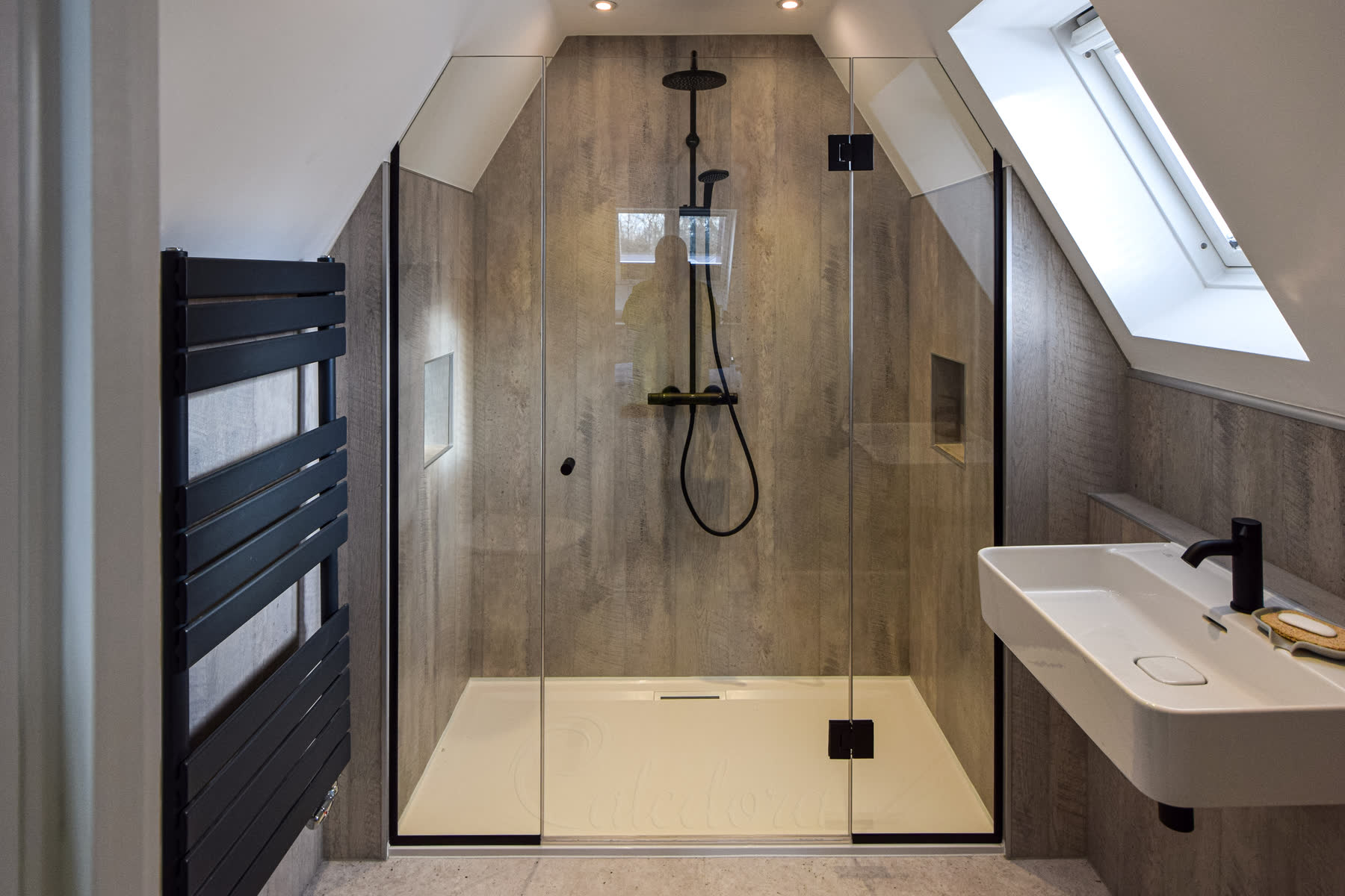 Complete slanted ceiling shower installation showing loft conversion bathroom design