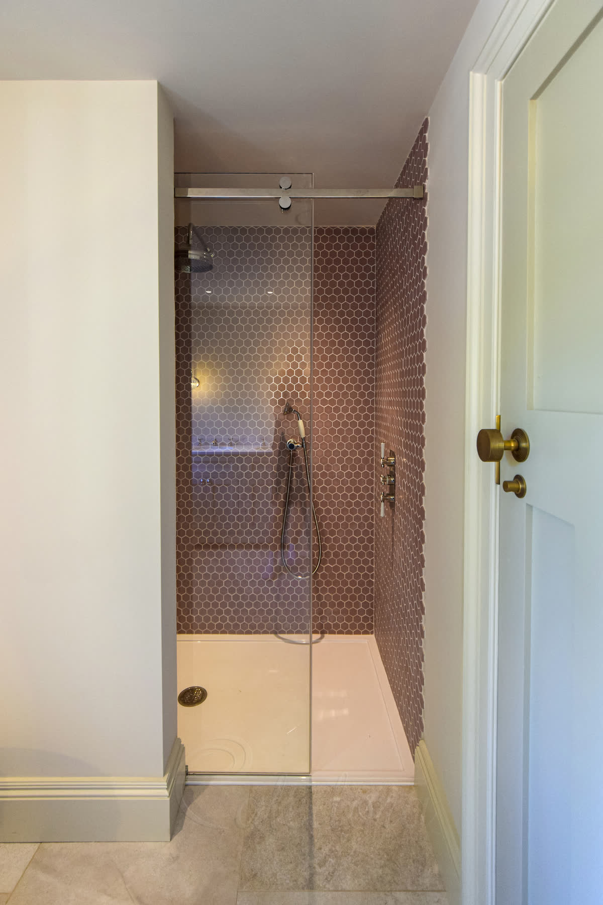 Sliding shower door track system with polished chrome finish and wall-mounted rollers for smooth operation