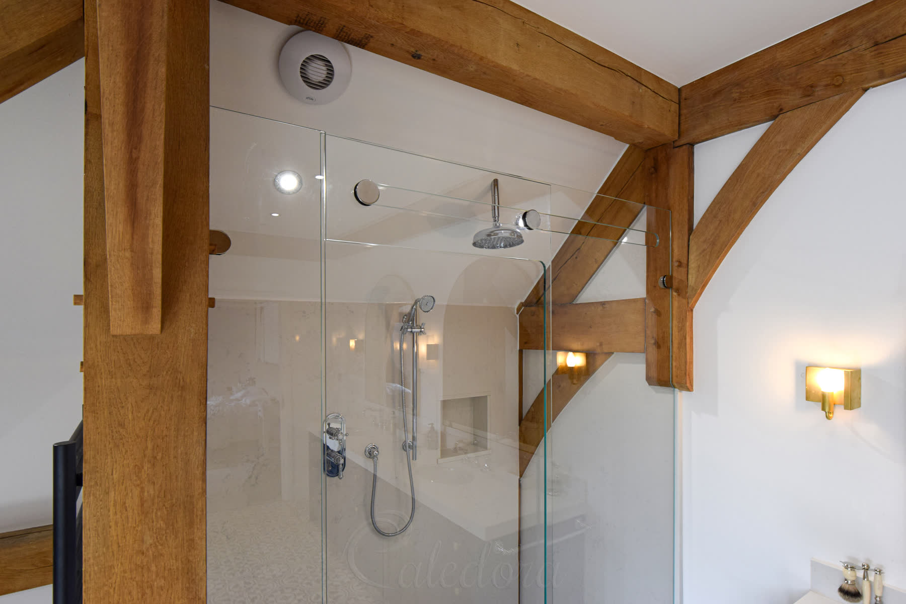 Chrome hardware and wall brackets supporting frameless sliding shower screen system in Basingstoke