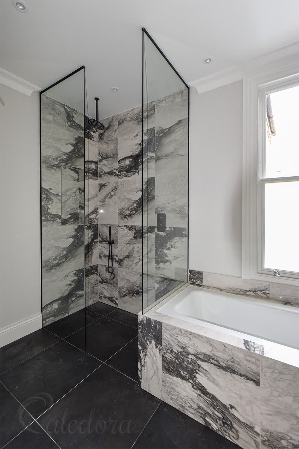 Full-height frameless shower screens with corner entry and black U-channel fixings