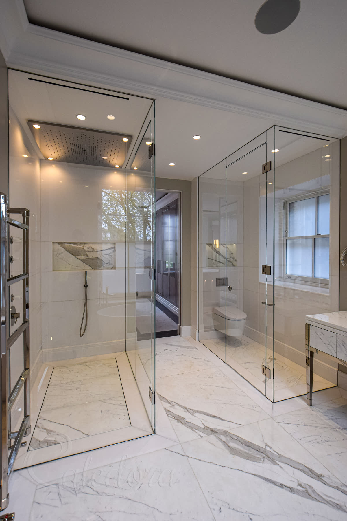 Hidden drain under marble slabs in a level wet room floor showing the recessed drainage joints in the London installation