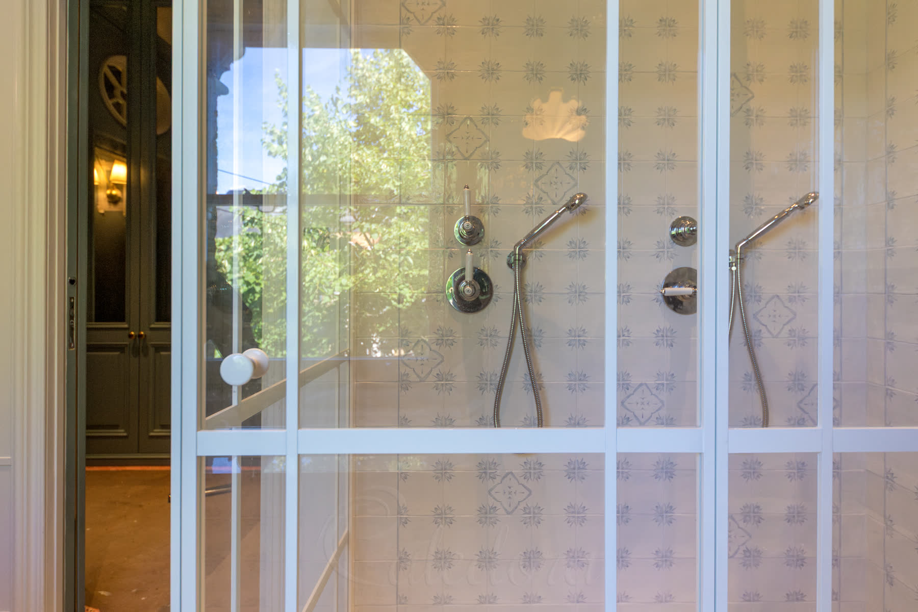 Closed white shower door showing consistent vertical grid lines