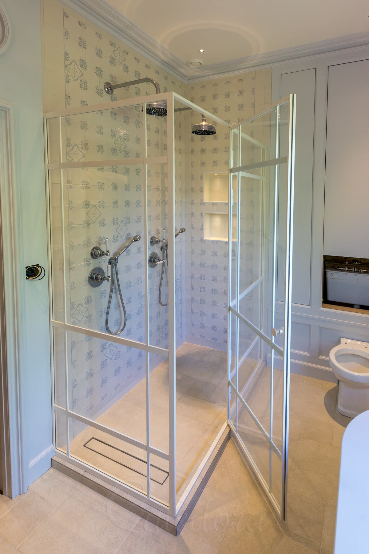 Entry positioning creating balanced grid design in shower