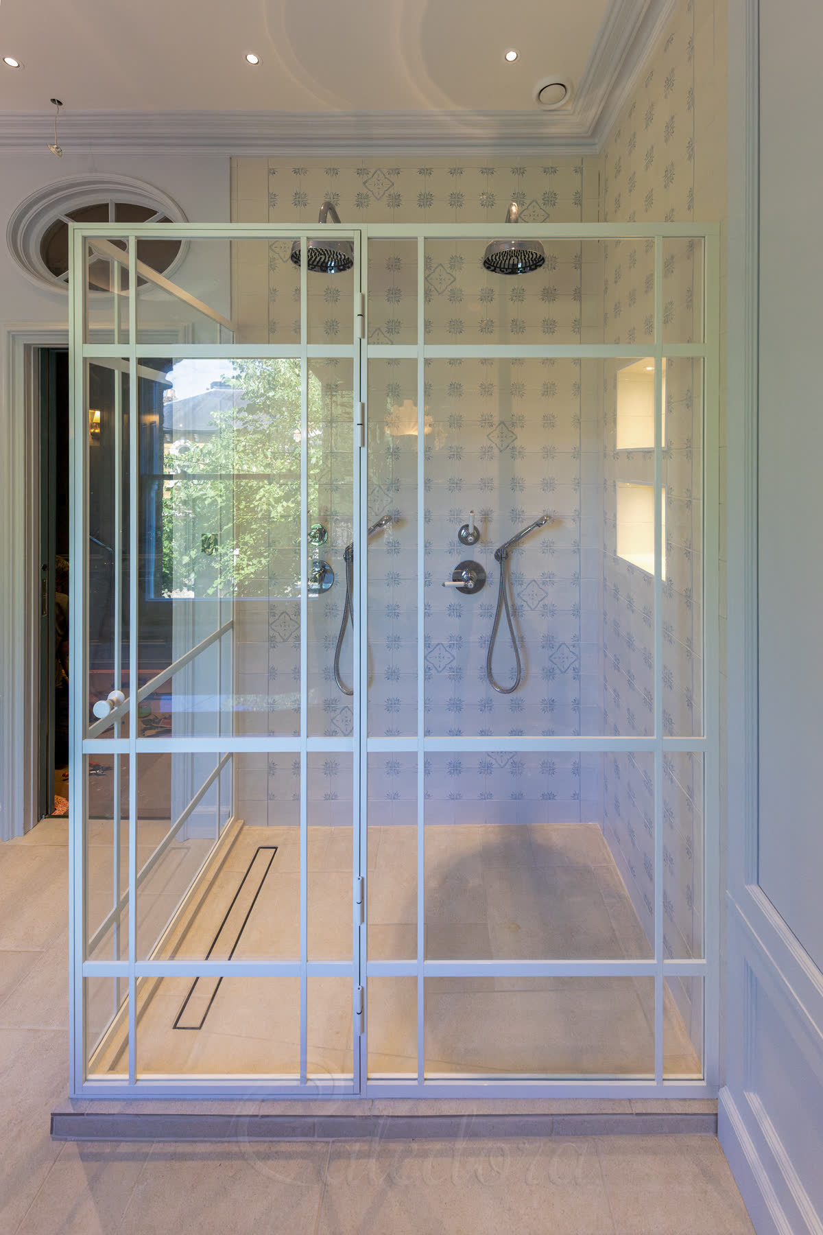 White framed shower enclosure with grid design and two showerheads