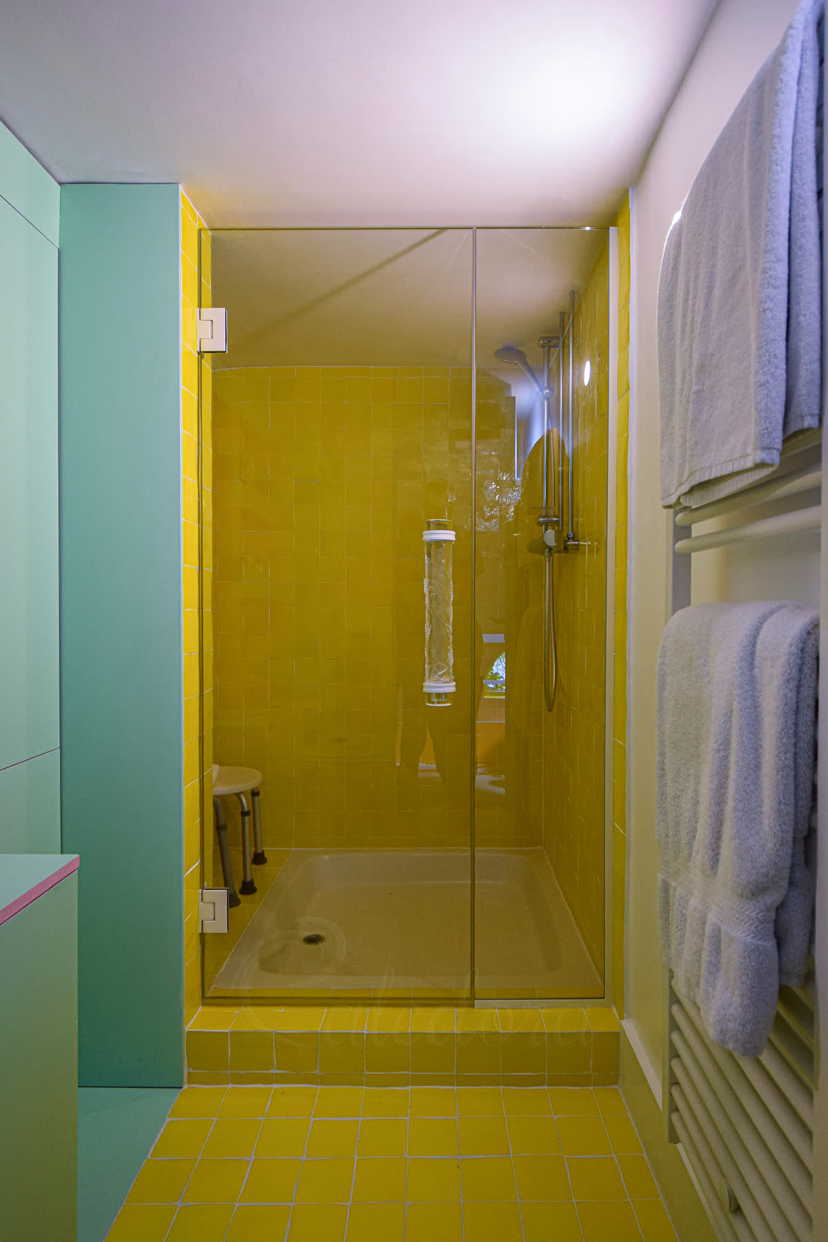 White hinged shower door in alcove enclosure with 650mm door and 350mm fixed panel