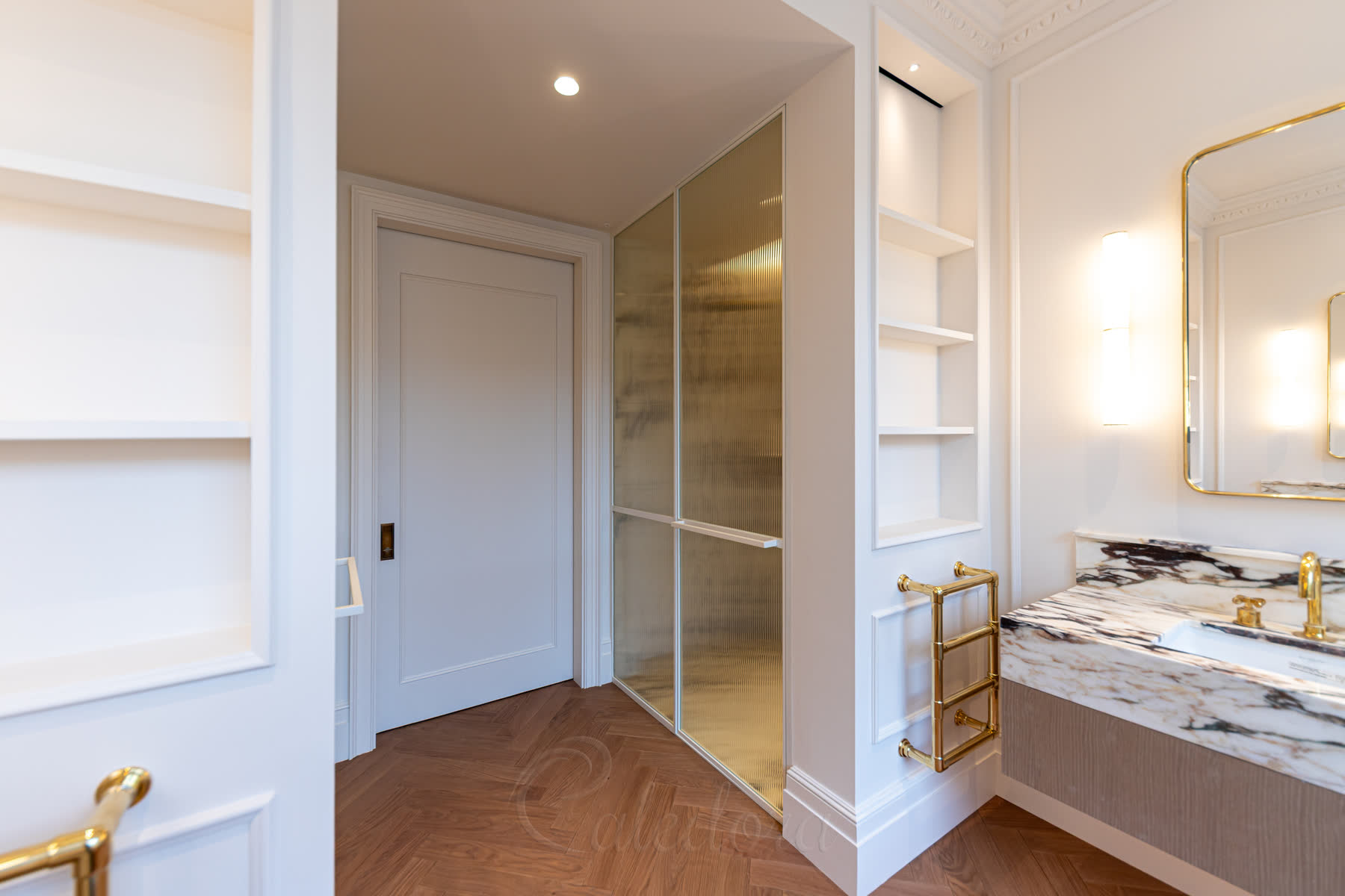Close-up of white framed shower door with fluted glass panels and horizontal divider bar