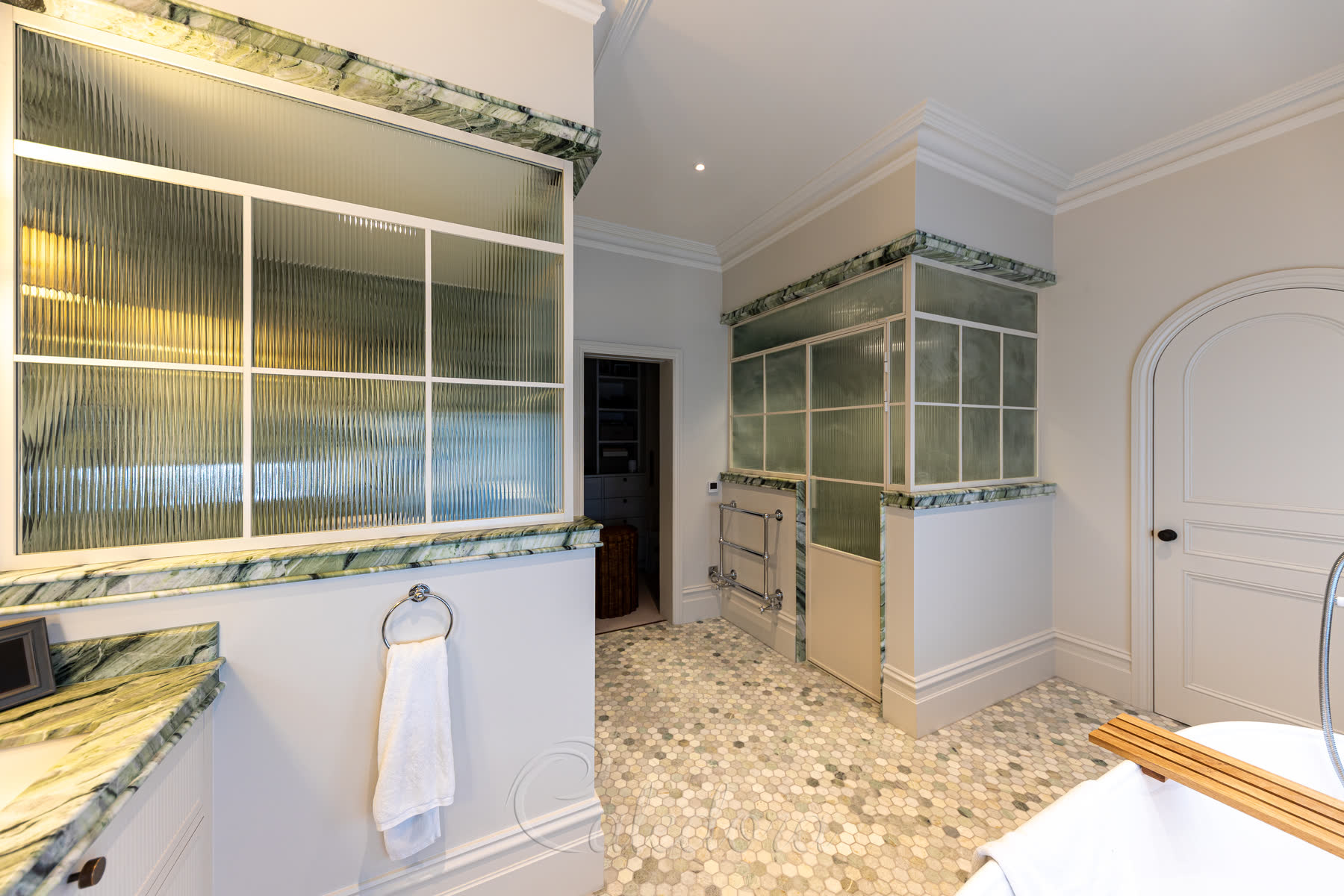 View of both white grid enclosures in the bathroom