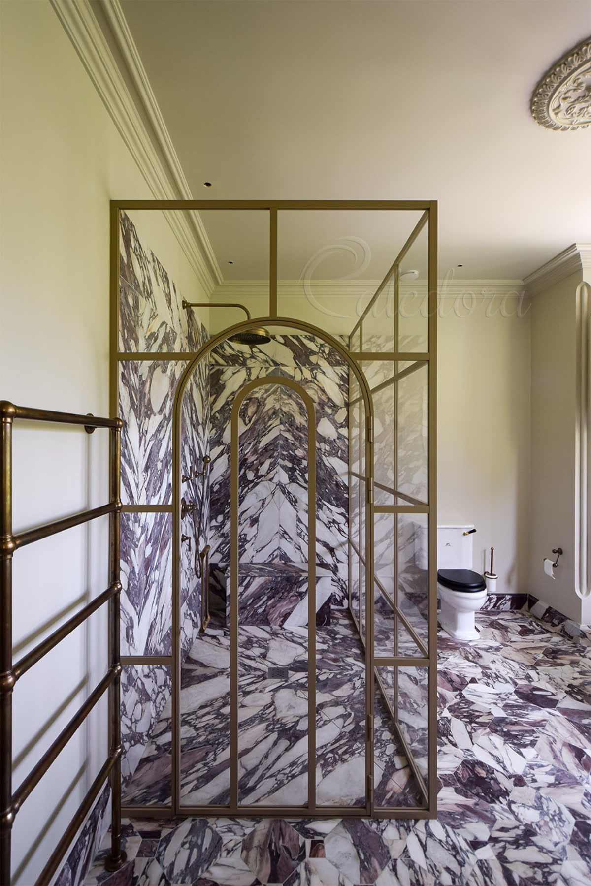 Bespoke arched glass shower door with light grey grid framing and 8mm ultra clear glass — large corner enclosure with marble floor and walls, elegant archway entrance