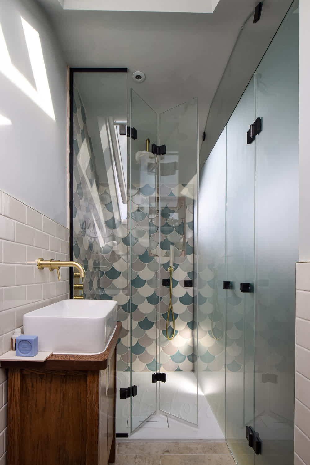 Bifold glass shower door in a tiny space with folding mechanism