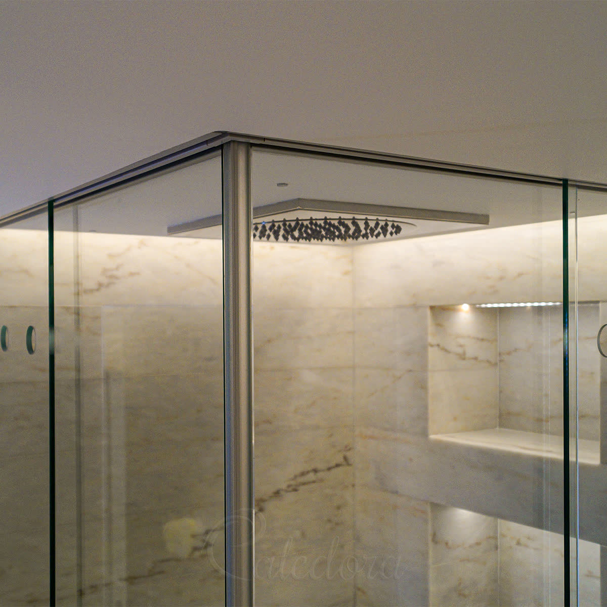 Sliding track recessed flush into the ceiling surface — only the glass and the bottom face of the track stay visible from below