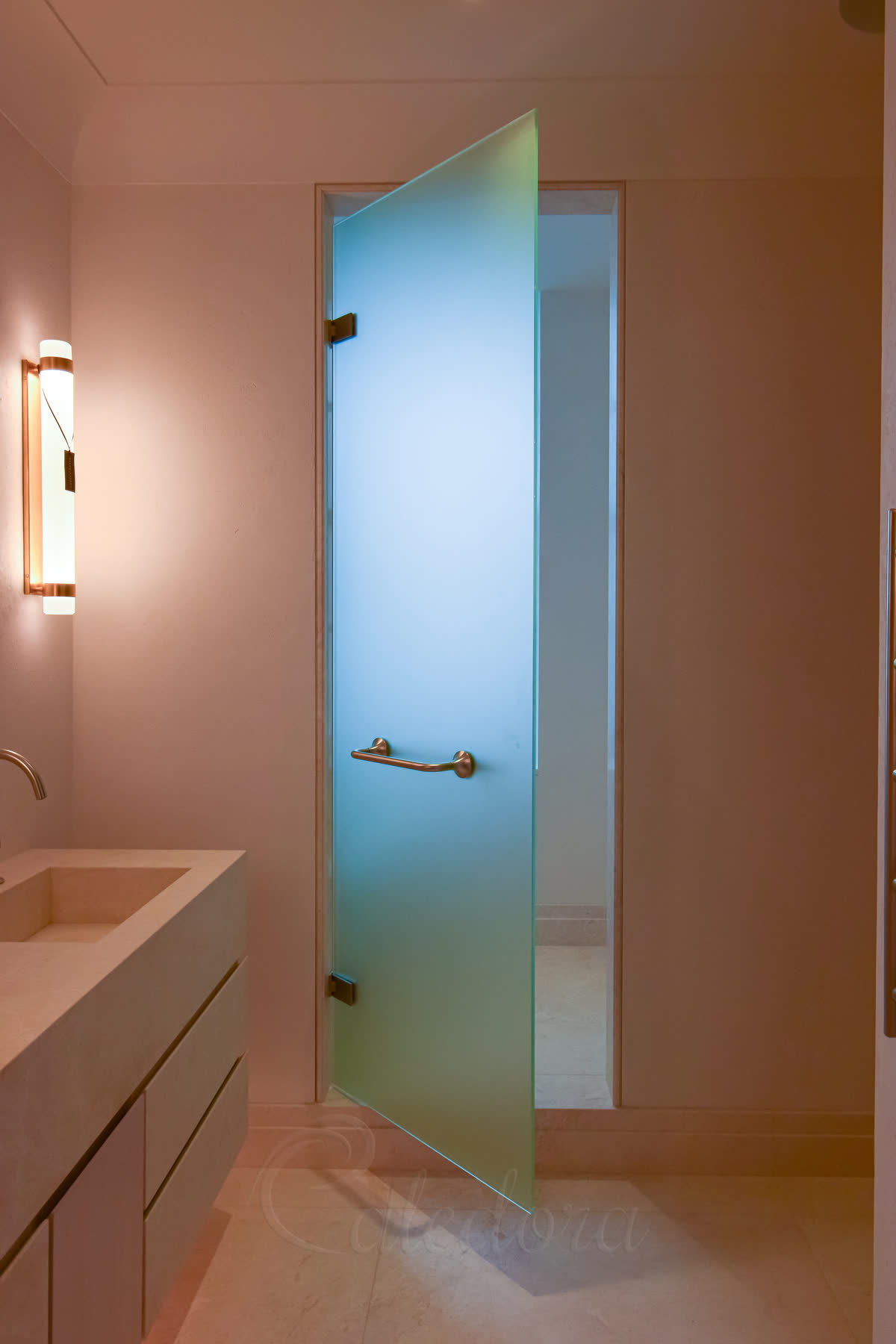 Frameless frosted hinged shower door with brushed nickel horizontal hinges and towel rail handle in modern bathroom