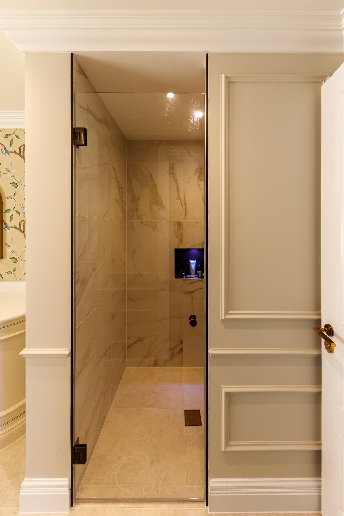 Frameless traditional hinged shower door with antique brass hinges and doorknob, minimalistic seals, swing both ways design in classic bathroom