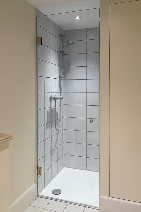 brathroom with white tile and ultra clear shower door