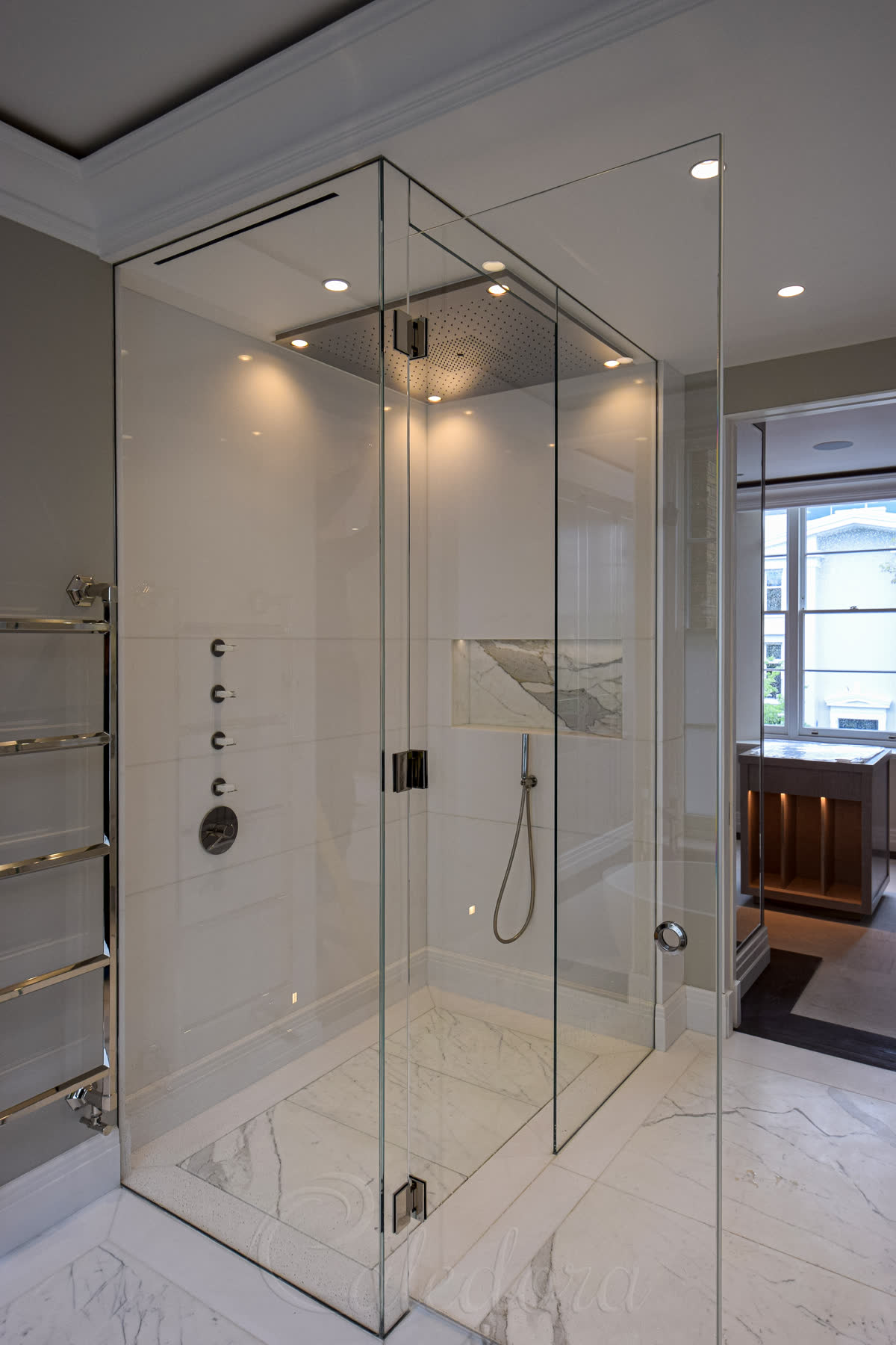 Wet room shower enclosure with level-access floor, full-height polished nickel hinges, marble throughout
