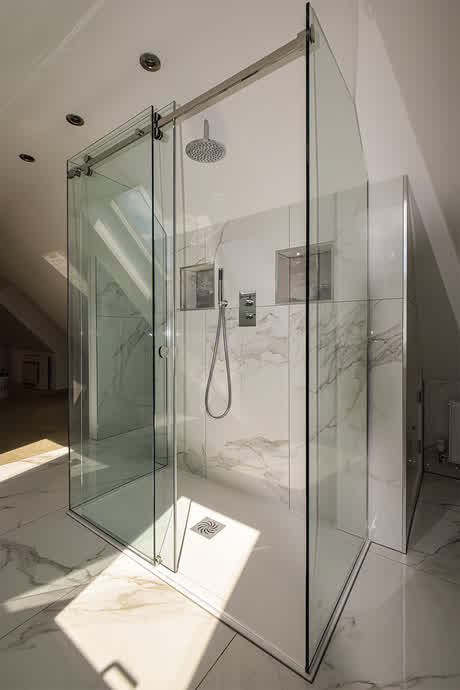 three sided shower enclosure with a sliding door