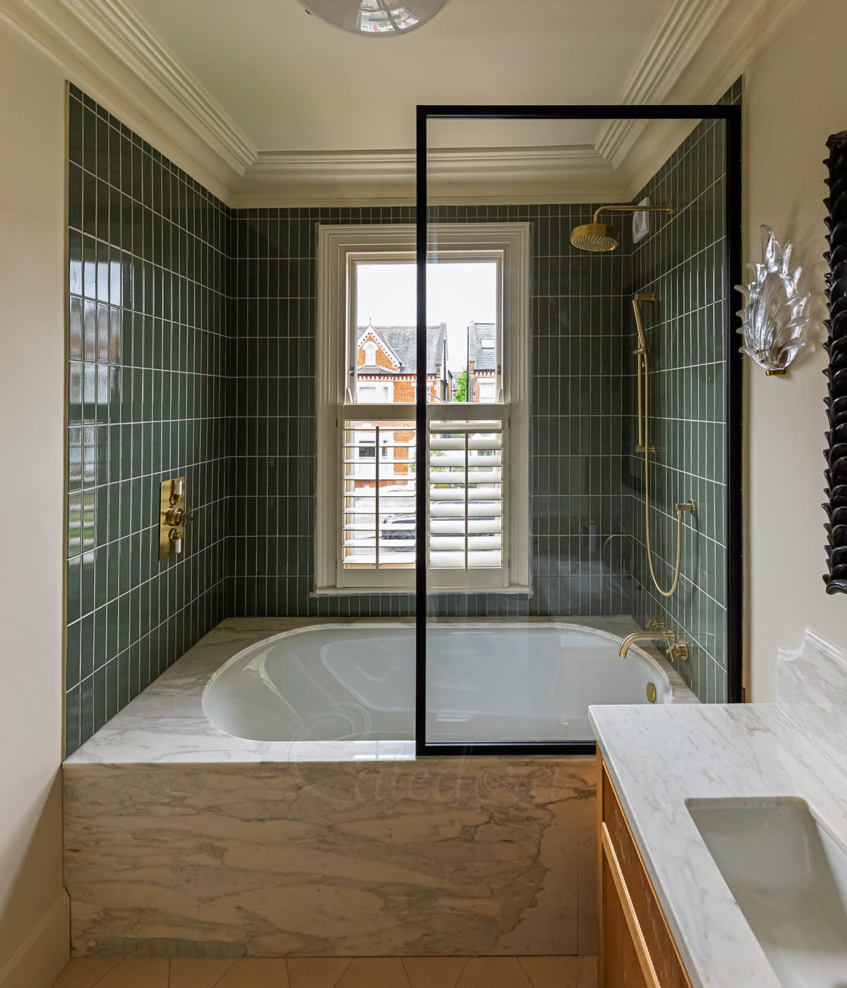 Black framed L-shape bath screen in a Central London bathroom