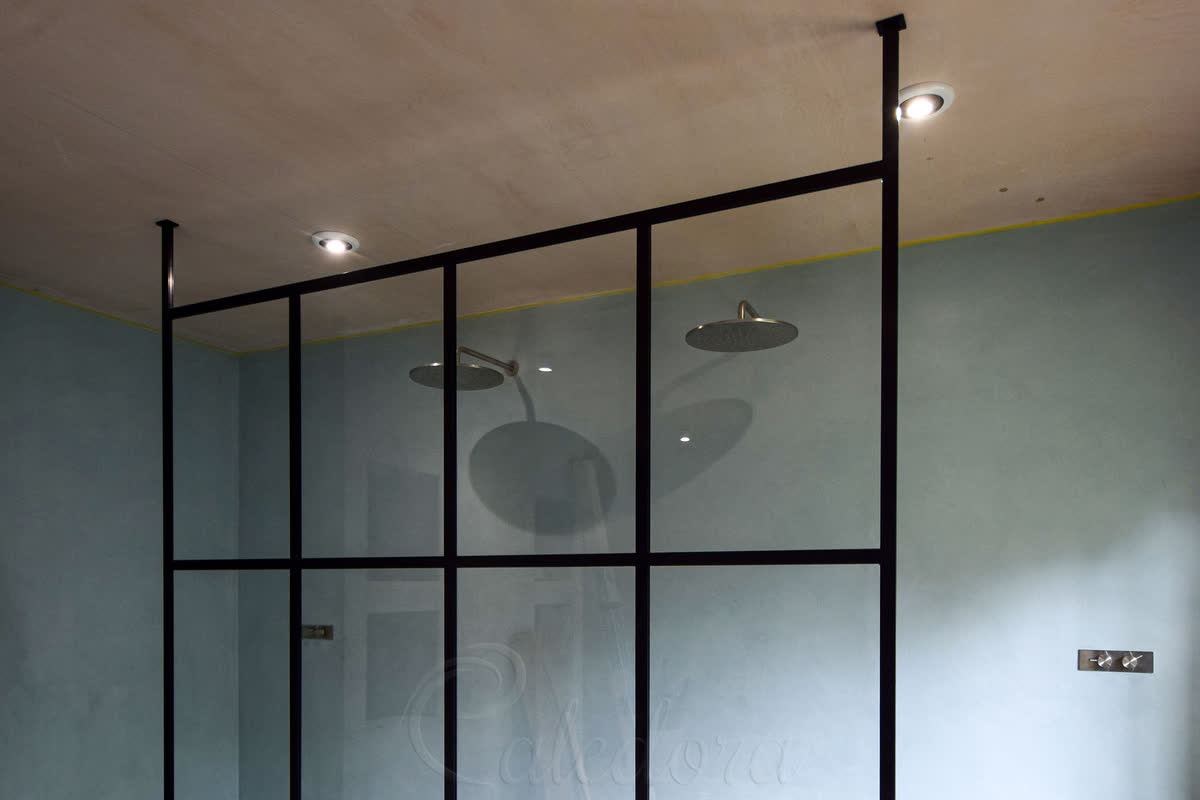 Black grid walk-in shower screen with full-height design and microcement walls in Lewes