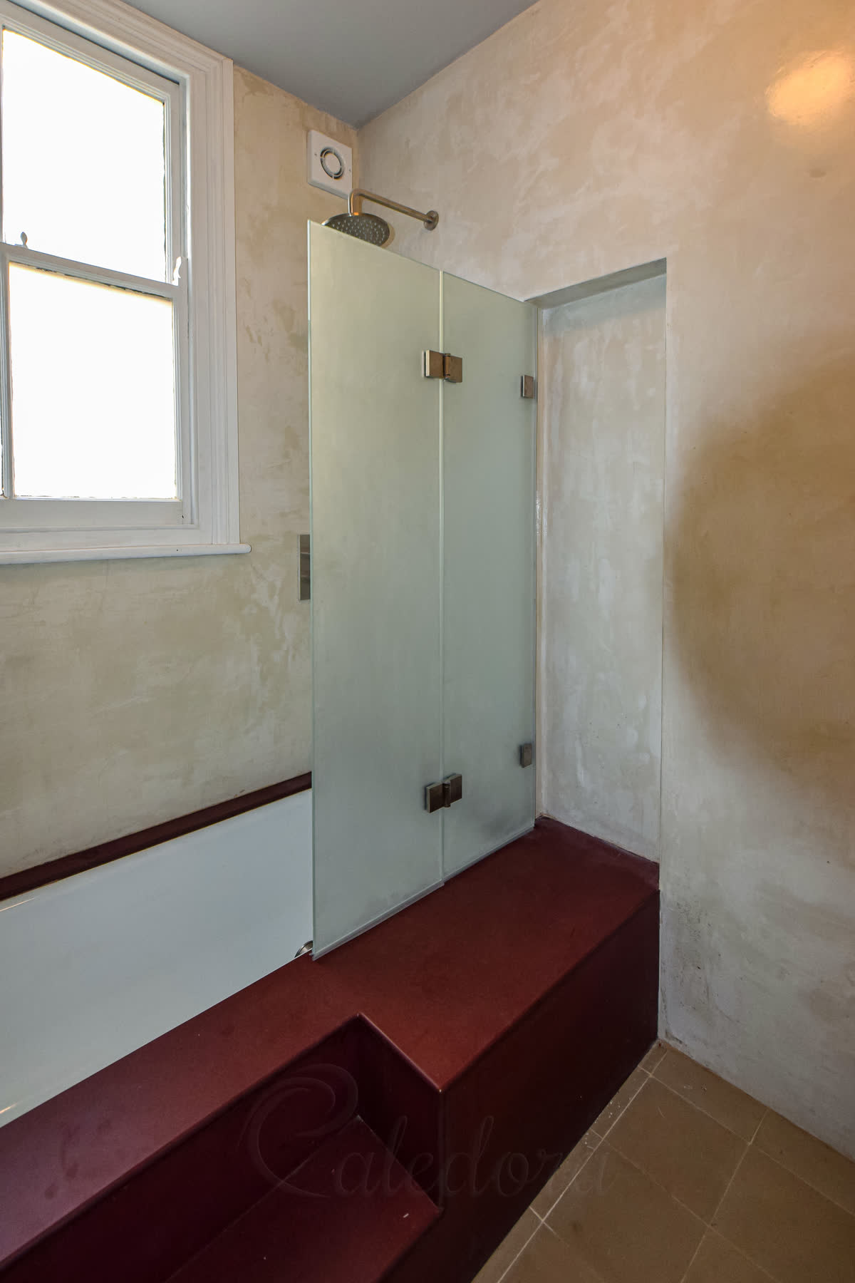 Acid-etched frosted glass folding bath screen blocking sight-lines while letting daylight through, in a London bathroom